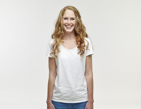 Portrait of smiling young woman with long blond hair