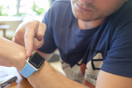 Young man using smartwatch, close-up