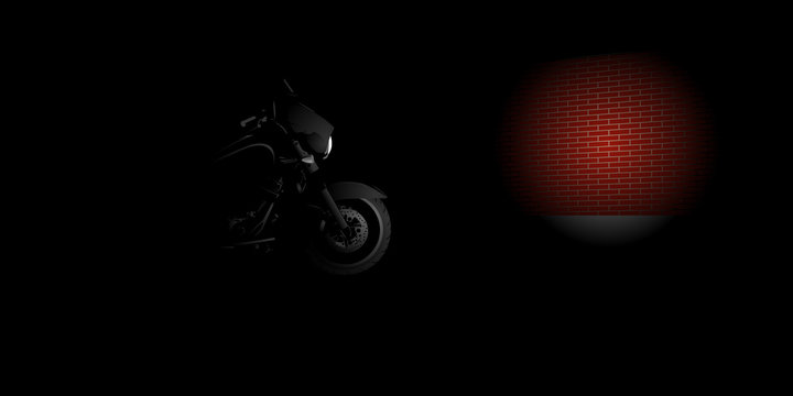 Heavy motorcycle front light on a red brick wall in the night