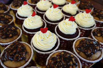 cupcakes with cream cheese frosting and a red heart