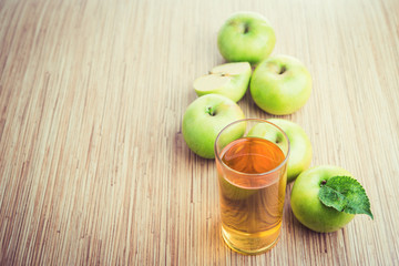 glass of juice and fresh apples