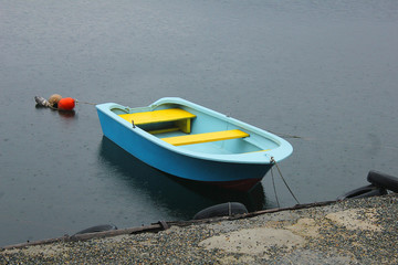blu and yellow boat on the lake