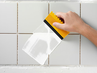 TILING AND GROUTING A WALL - obrazy, fototapety, plakaty