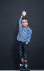 Cheerful smiling boy drinking milk
