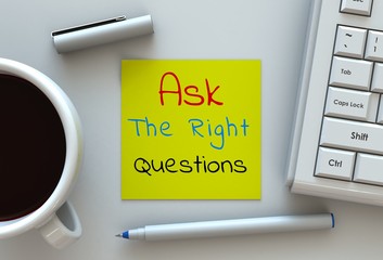 Ask The Right Questions, message on note paper, computer and coffee on table