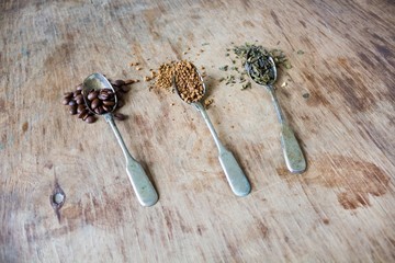 Spoons with green tea and coffee beans