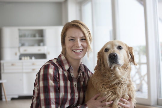 Portrait of smiling young woman with her dog