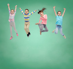 happy little girl jumping in air over school board