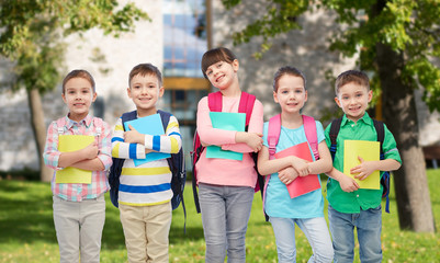 Fototapeta na wymiar happy children with school bags and notebooks