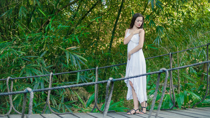 Young woman is relaxing on the hanging bridge