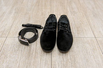 black bow tie and leather shoes groom lying next to belt of trousers. Groom accessories, businessman, 