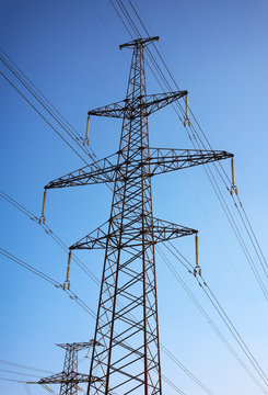 Electricity Pylon and Power Lines on Blue Sky Background