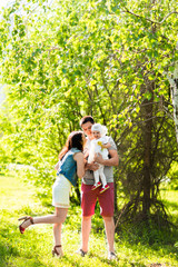 happy young family spending time outdoor on a summer day