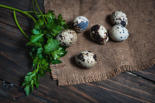 Quail eggs with parsley on a wooden table