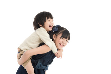  girl giving her brother piggyback ride