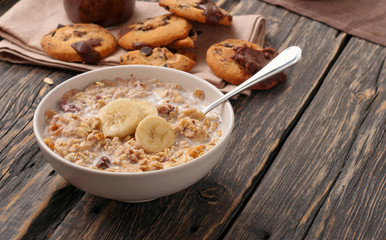 oatmeal with milk and bananas in white bowl