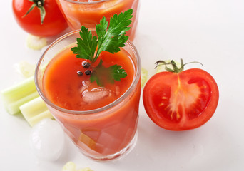 glass of fresh tomato juice on white background