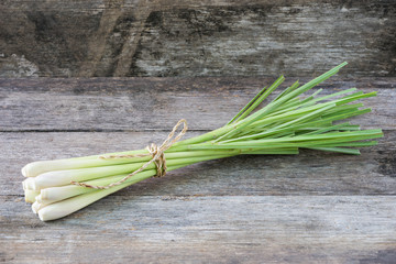 Fresh lemongrass (citronella) on wooden background - Spice for h