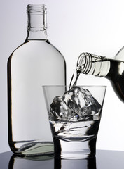 POURING GLASS OF GIN