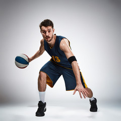 Full length portrait of a basketball player with ball 