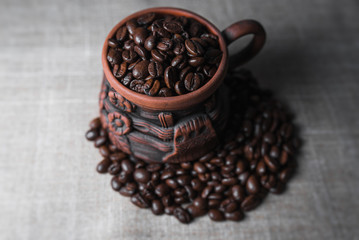 Coffee beans on background in cup