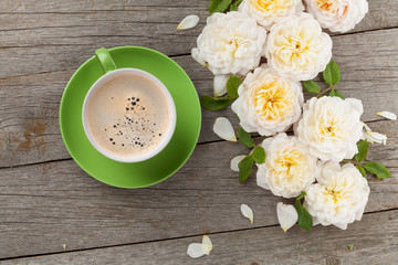 Cup of coffee and white roses
