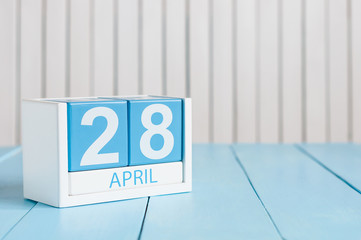 April 28th. Tax Day. Image of april 28 wooden color calendar on white background.  Spring day, empty space for text