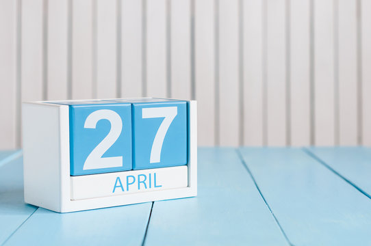 April 27th. Image of april 27 wooden color calendar on white background.  Spring day, empty space for text