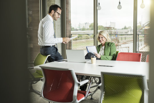 Two business people communicating in an office