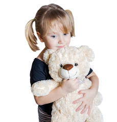 Little girl holding a teddy bear