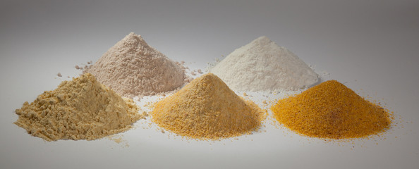 Corn, rice and sorghum flours on a white background