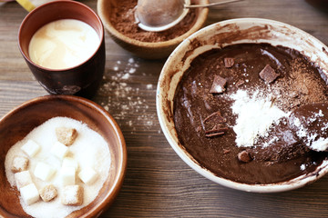 Preparing dough for chocolate pie on table close up
