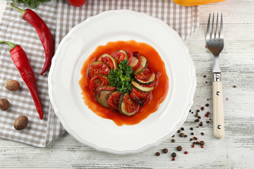Ratatouille on plate, on table background