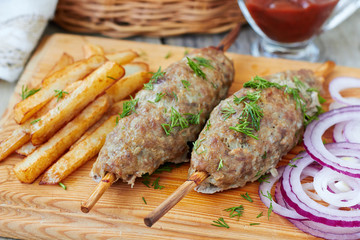 Barbecued kofta -traditional shish kebab from lamb meat on skewers,horizontal
