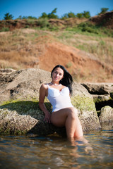 Beautiful girl sunbathing and swimming in the sea