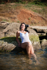 Beautiful girl sunbathing and swimming in the sea