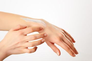 Cropped shot of a woman applying lotion to her hands.Keeping her hands silky and smooth