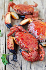 Boiled crabs on wooden surface