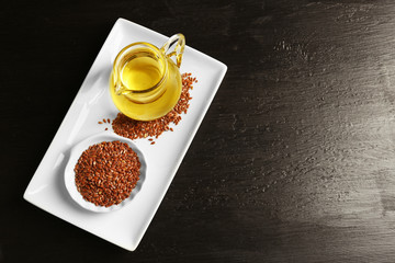 Flax seeds with oil on wooden table