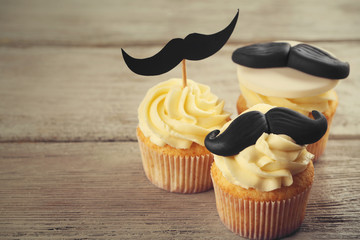 Delicious creative cupcakes on wooden table