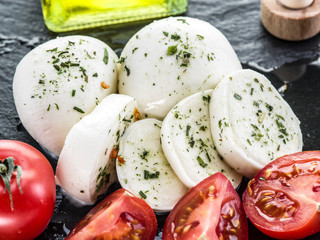 Mozzarella and tomatoes. Dark grey background.