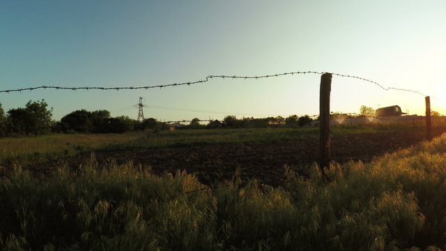 Barbed wire fence summer