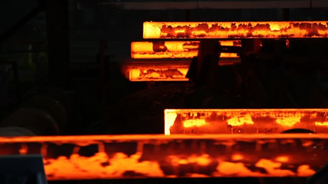 Hot steel ingots on conveyor