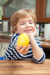Fototapeta premium Small boy with yellow Easter egg.