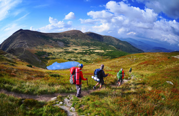 Group of hikers in the mountains, view of Carpathian mountains