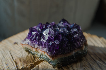 Raw amethyst rock with reflection on natural wood crystal  ametist