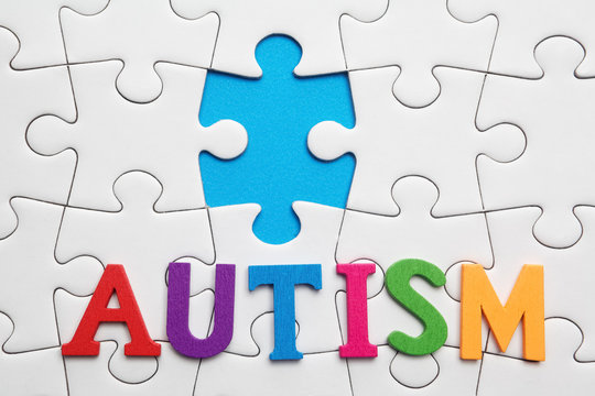 Autism inscription on a white puzzle background