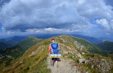 Fototapeta premium Group of hikers in the mountains, view of Carpathians mountains in Ukraine