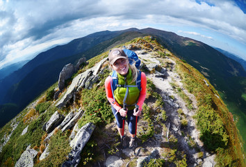 Woman hiker walking in mountain landscape, Carpathian Ukraine