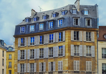 Fototapeta na wymiar View of unique traditional French windows and balconies. Paris 